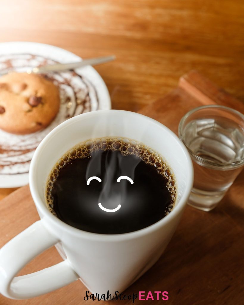 A cup of coffee with a smiley face on it.