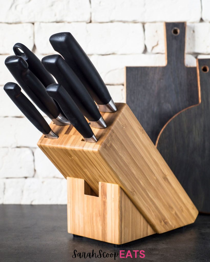 wooden knife block with knives with black handles