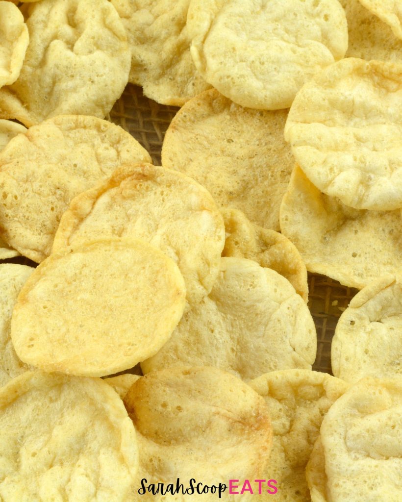 A pile of potato chips on a cooling rack.