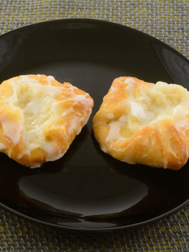 two cheese danishes on a black plate