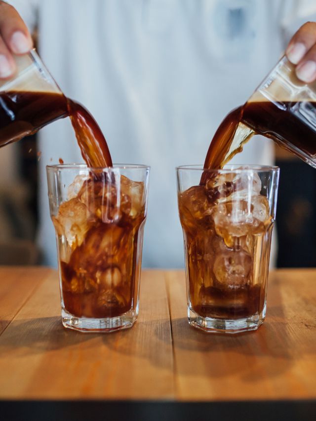cold brew concentrate being poured into two glasses