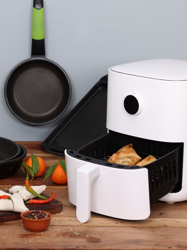 white air fryer cooking on top of counter