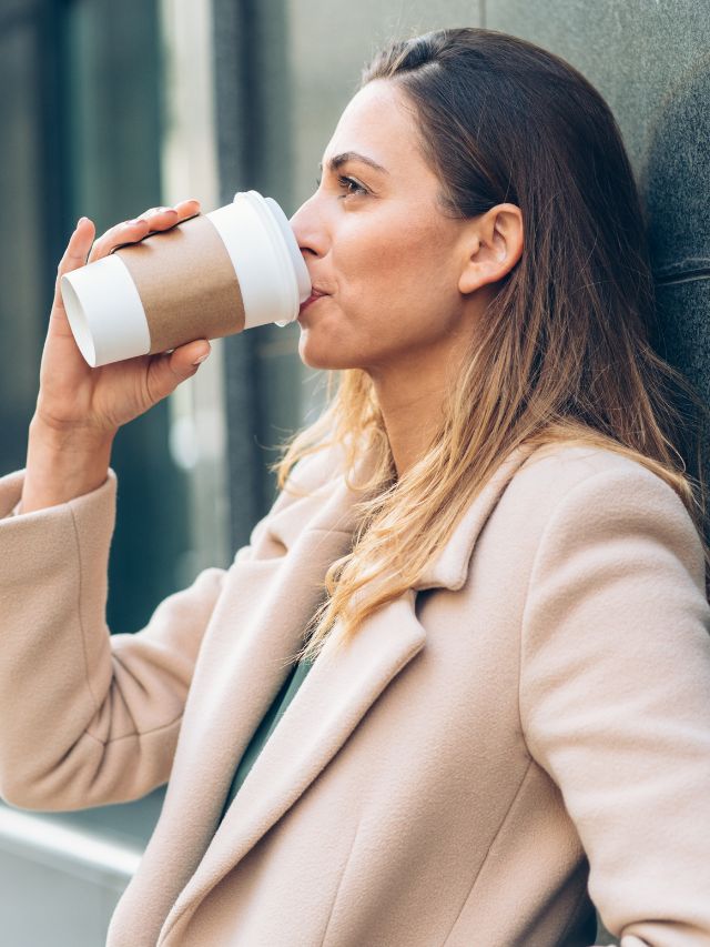woman sipping on her cup of coffee
