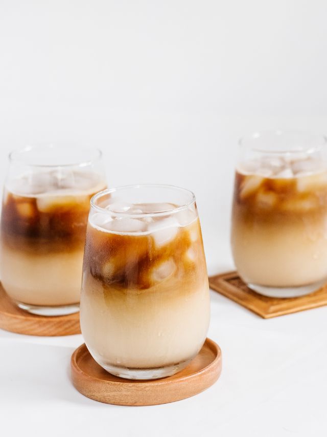 iced coffee in cups on wooden coasters