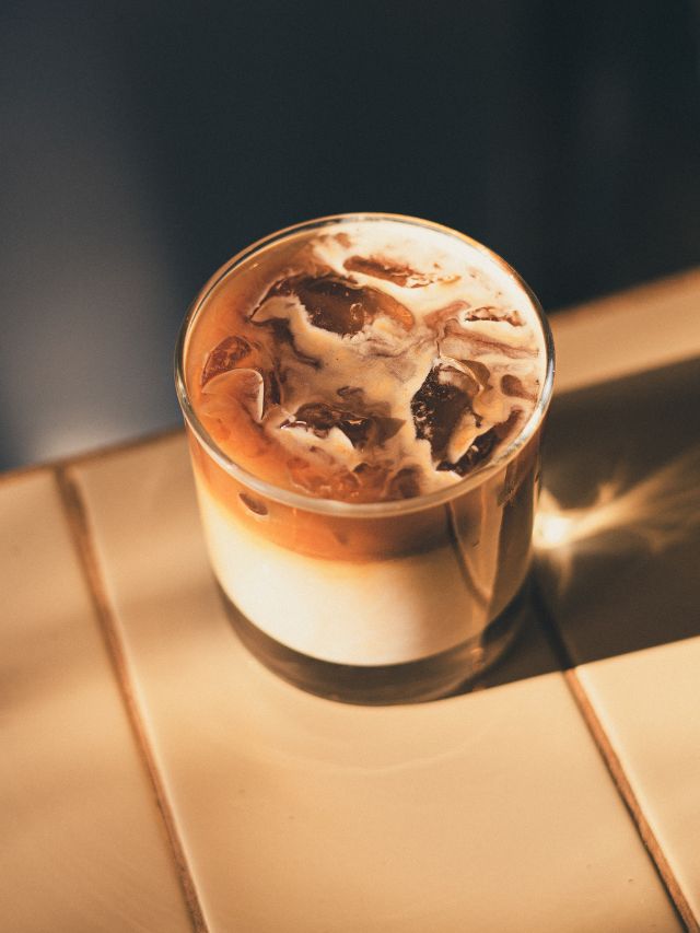 iced coffee in a glass on a table with ice