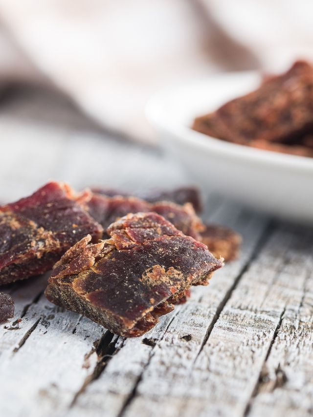 closeup of beef jerky on wooden table