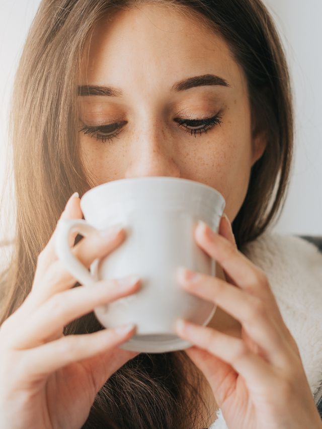 woman drinking from her coffee mug