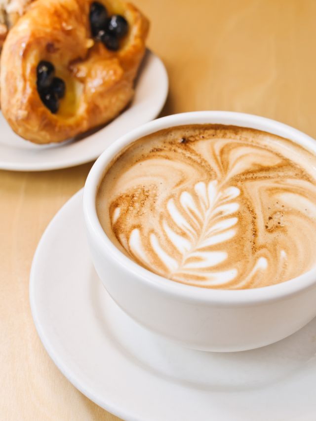 cappuccino in a mug with food on a dish