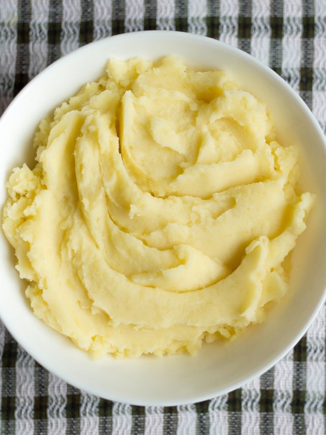 bowl filled with mashed potatoes on plaid background