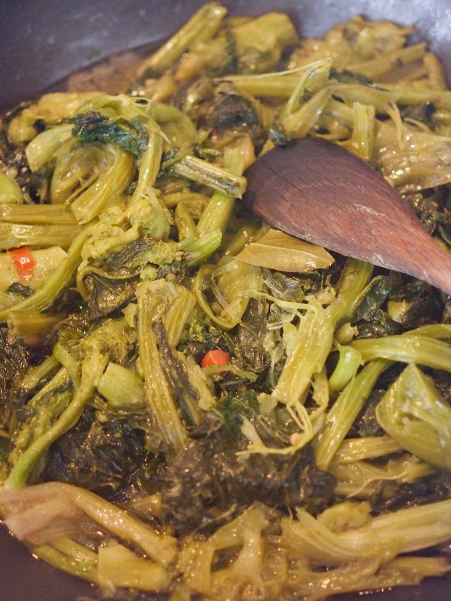 close up of turnip greens with spatula