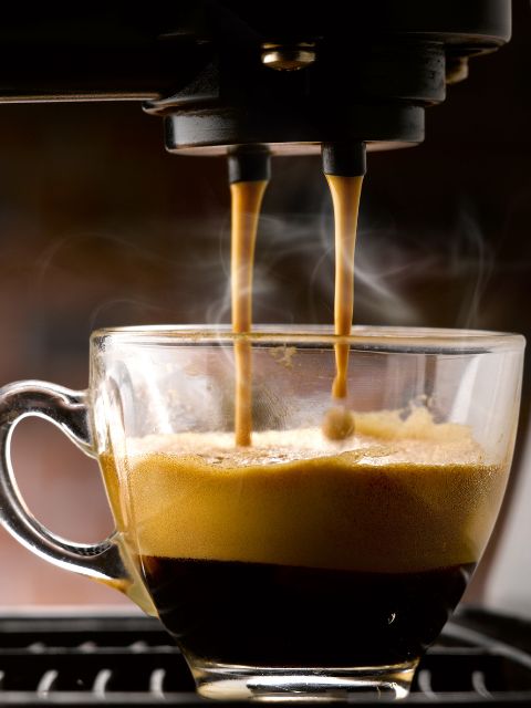 hot espresso being brewed into a cup