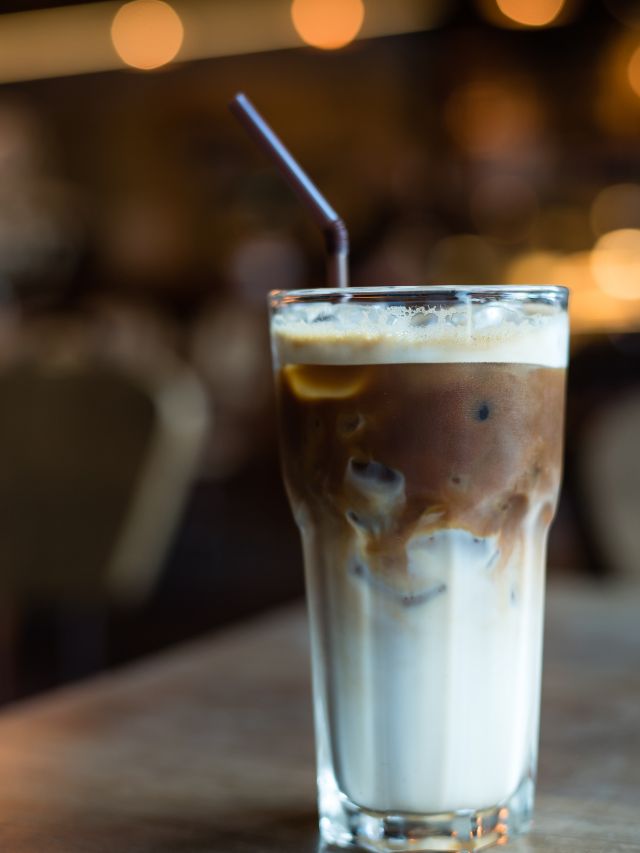 iced macchiato in glass with a straw