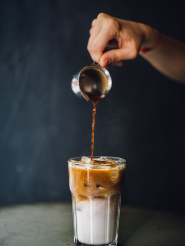 pouring espresso into iced latte