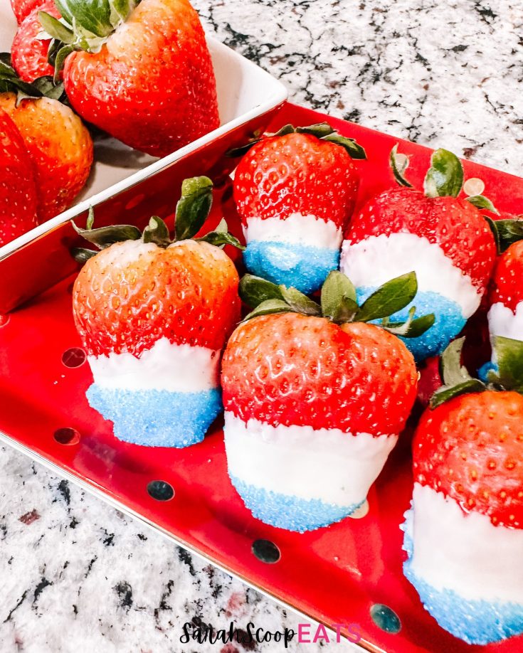 patriotic red white and blue strawberries for the 4th of july served on a red and gold dish