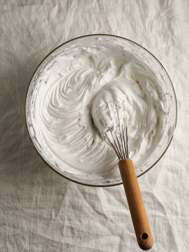 whisking whipped cream in a bowl