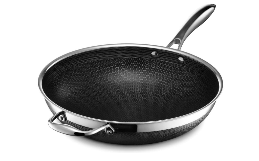 A black stainless steel wok on a white background.