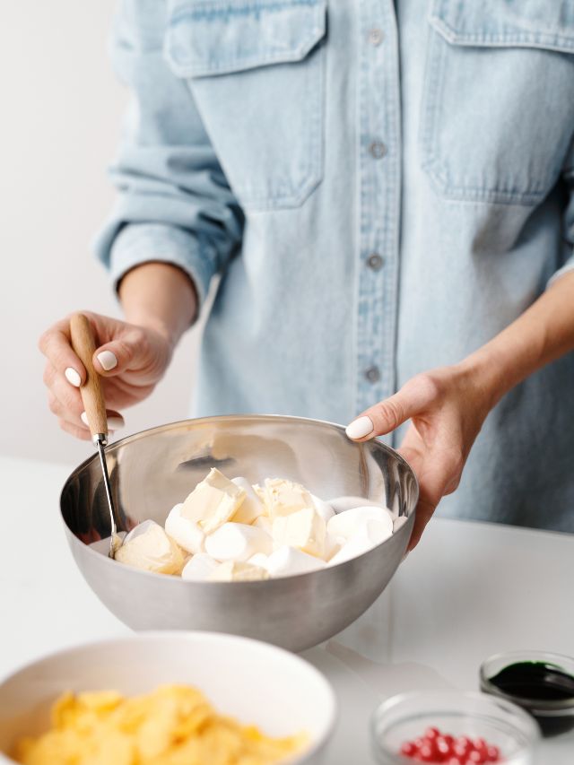 woman baking with a stainless steel bowl