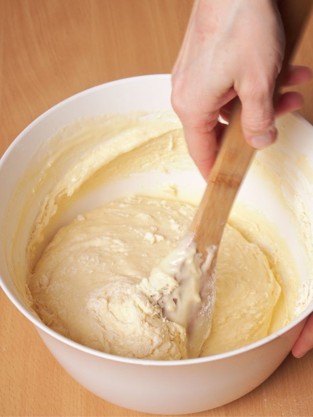 cake batter in bowl with wooden spoon