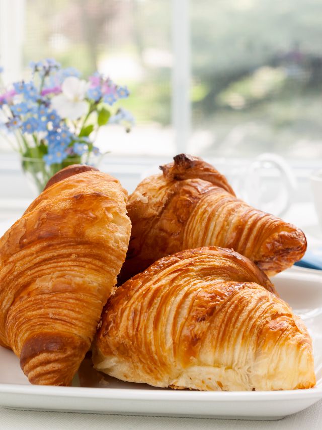 plate of croissants in home with flowers