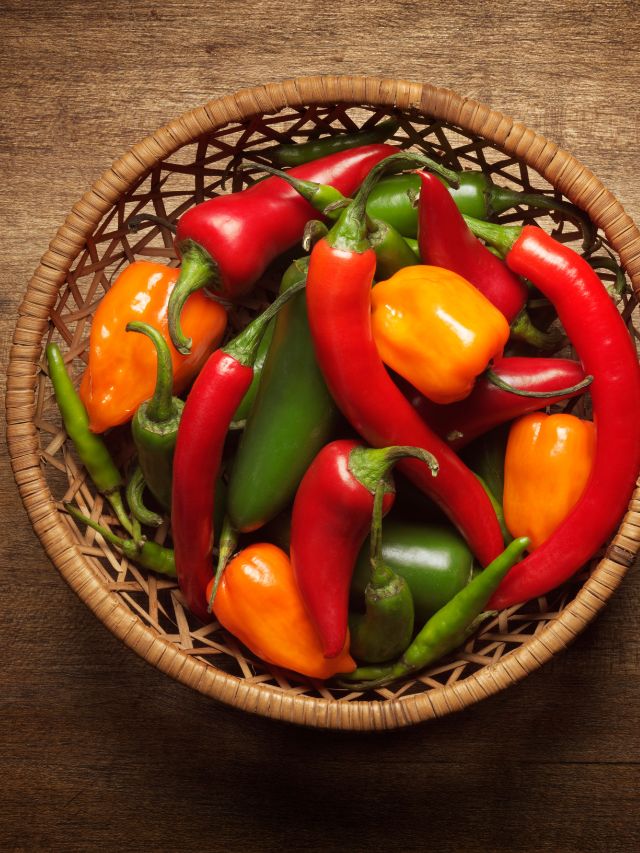 different types of peppers in woven basket