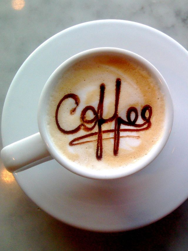 A cup of coffee with the word coffee written on it.