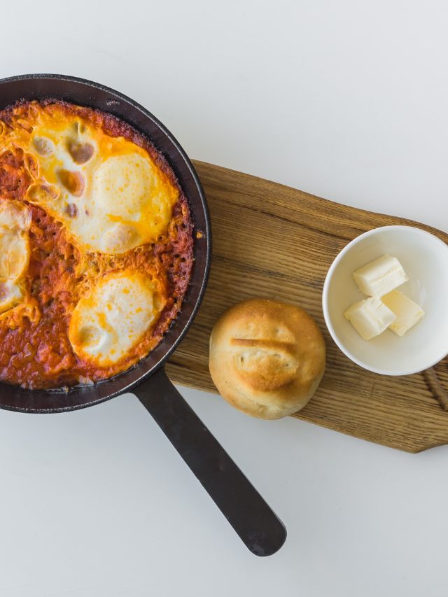 skillet with shakshuka with bread and butter