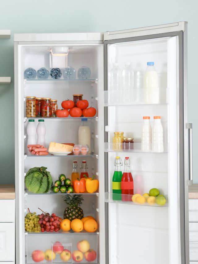 tall fridge open with food inside