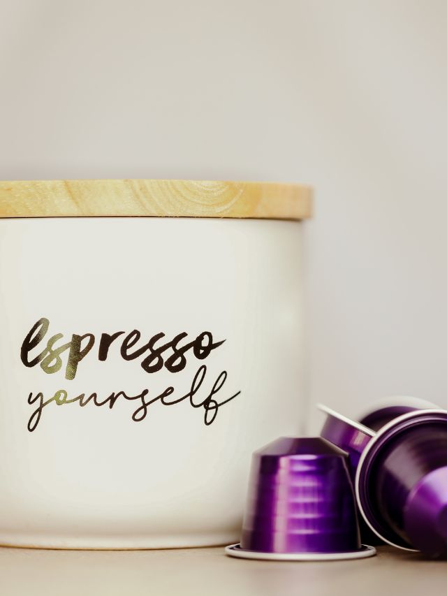 A white container with purple coffee pods and the words l'espresso yourself.