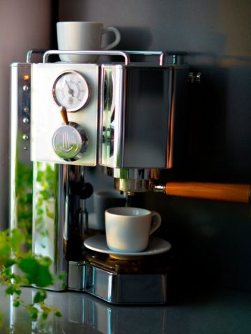 A coffee machine with a cup of coffee on it.