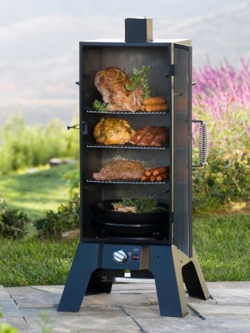 A barbecue grill with meat and vegetables on it.