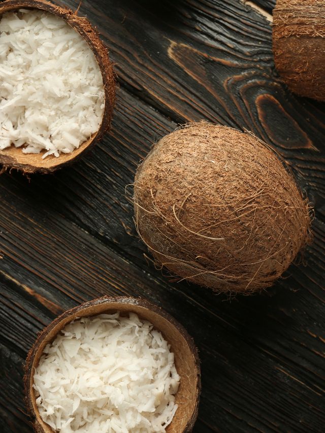 White rice in coconut shells on a wooden table, using coconut substitute.