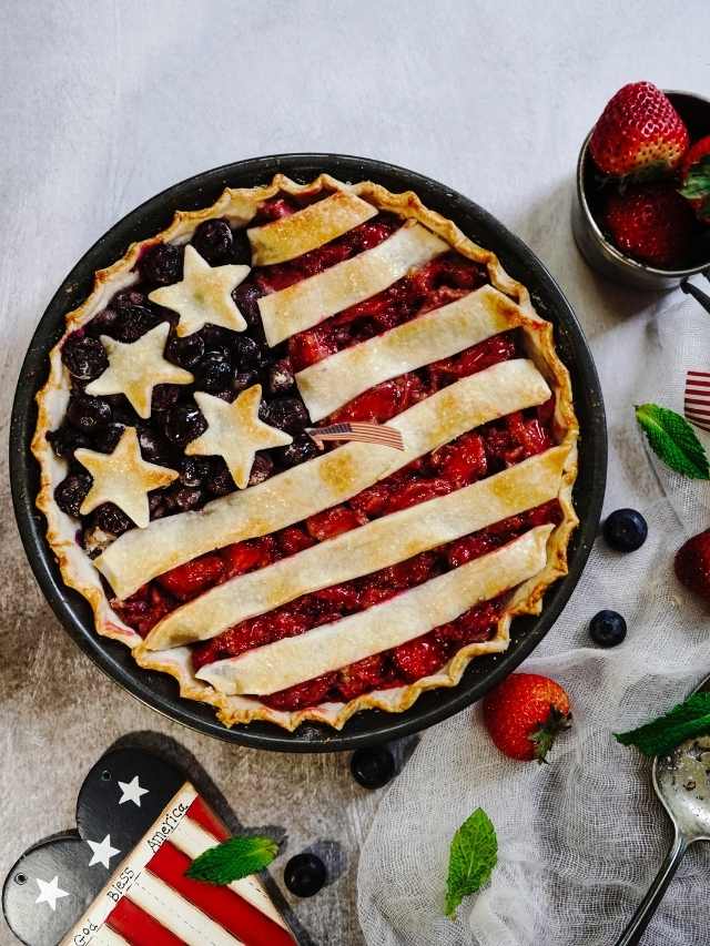 A patriotic pie with strawberries and blueberries.