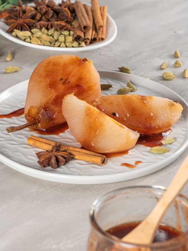 A plate with pears and spices on it.