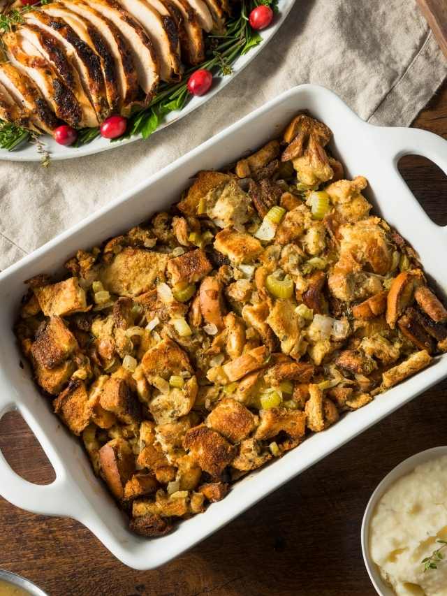 Thanksgiving stuffing in a white dish on a table.