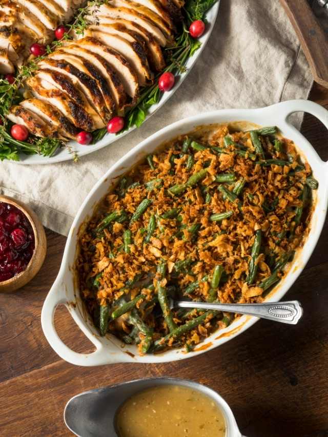Green bean casserole with cranberry sauce on a table.