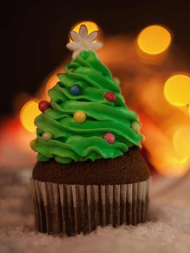 A cupcake decorated with a christmas tree.