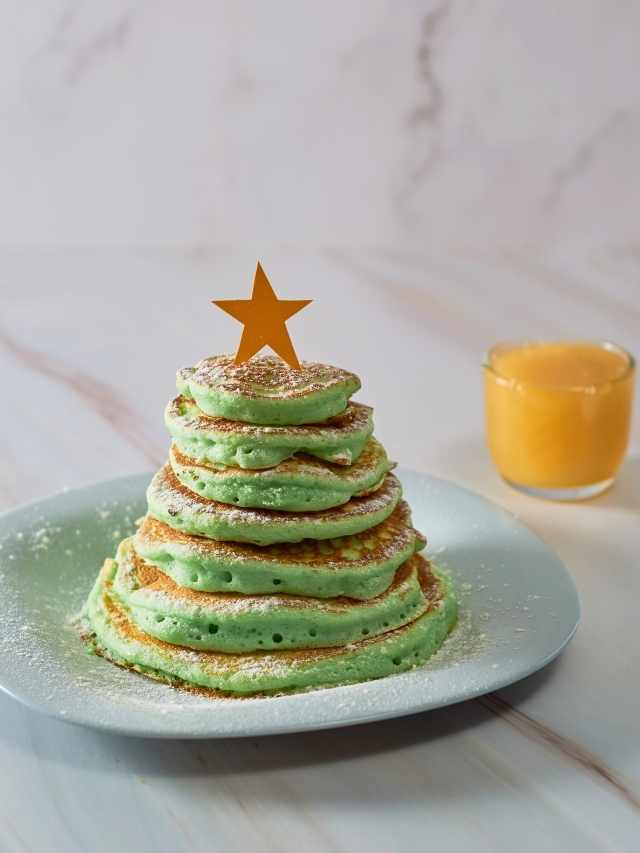 A stack of green pancakes with a star on top.
