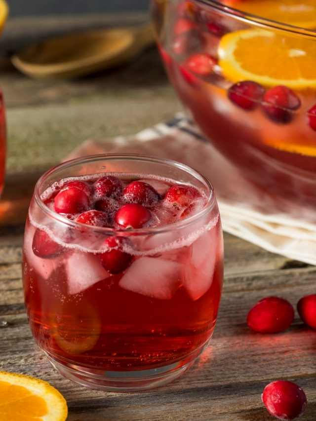 Cranberry punch with orange slices and ice.