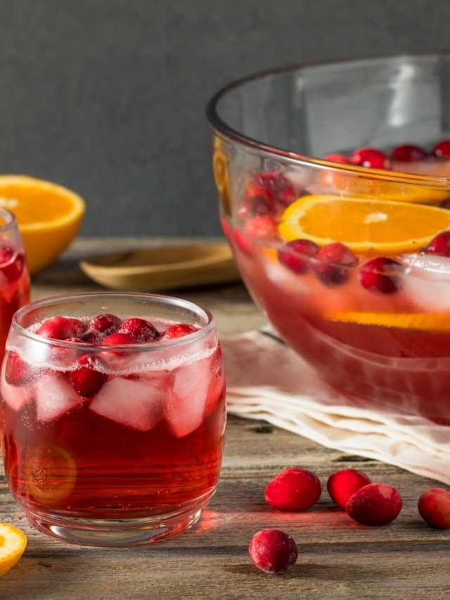 Cranberry punch with orange slices and ice.