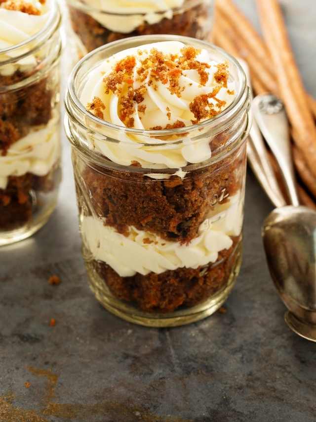 Carrot cake in a jar with cinnamon sticks.
