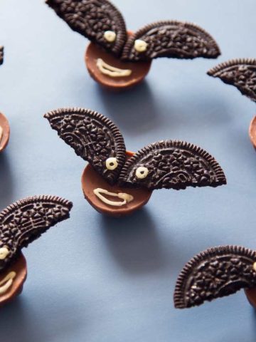 Oreo bat cookies on a blue background.