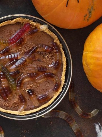 A chocolate pie with worms on top.