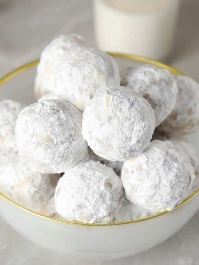 White powdered sugar cookies in a bowl.
