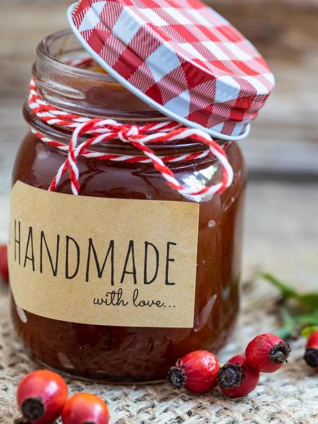Homemade cranberry jam in a jar with red berries.