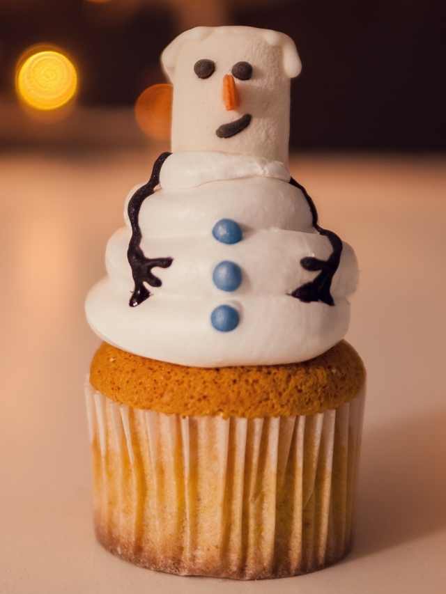 A cupcake with a snowman on top.