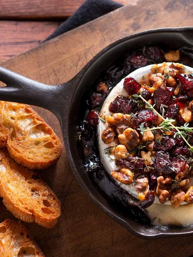 Cranberry brie dip in a cast iron skillet.