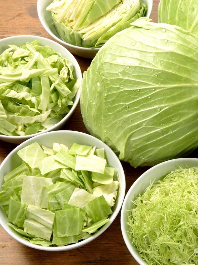 Cabbages in bowls on a wooden table.