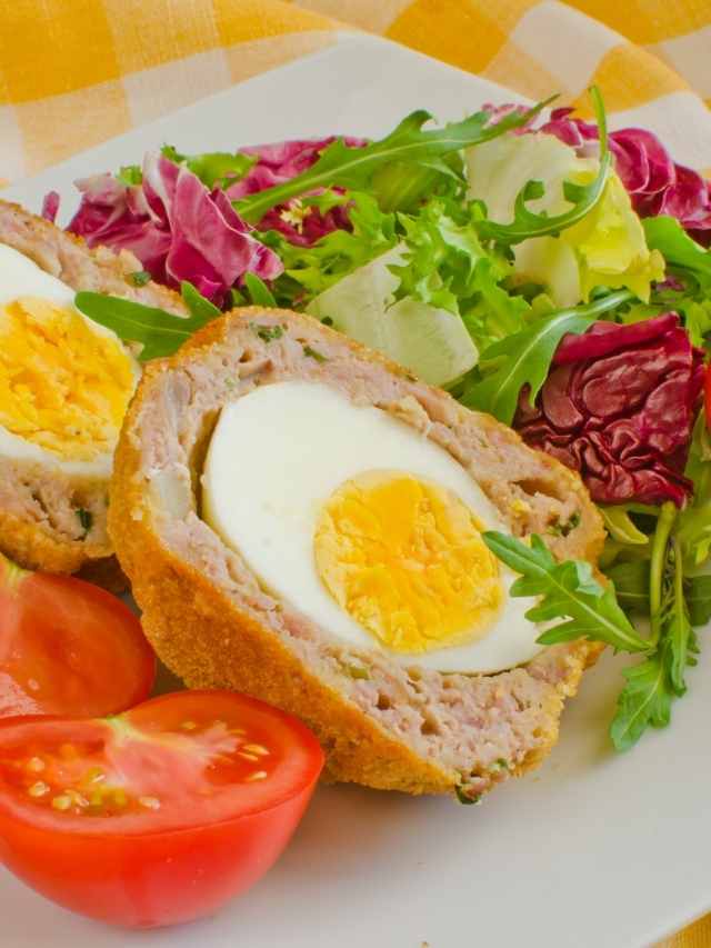 A plate with a fried egg and salad on it.