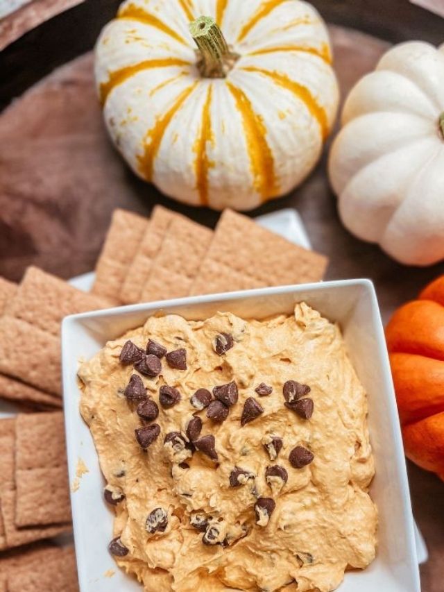 Pumpkin chip dip with crackers and pumpkins.